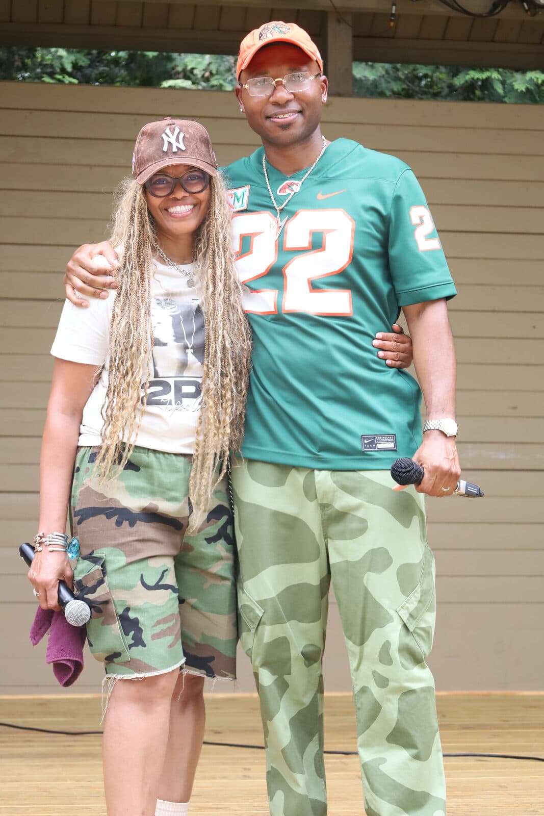 Pastor Yorie Gipson with a member on stage at an outdoor event