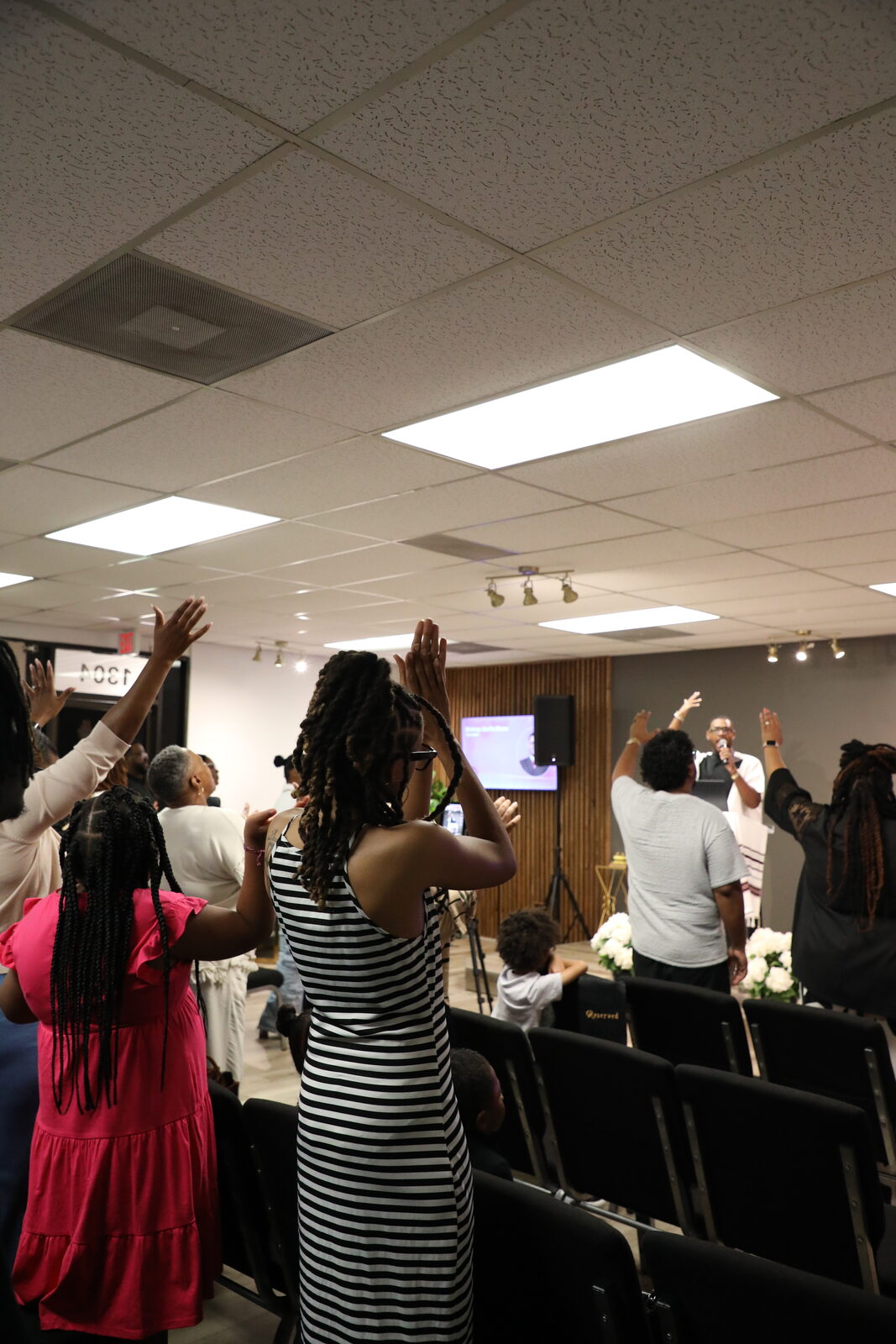 The congregation worshipping together with hands raised
