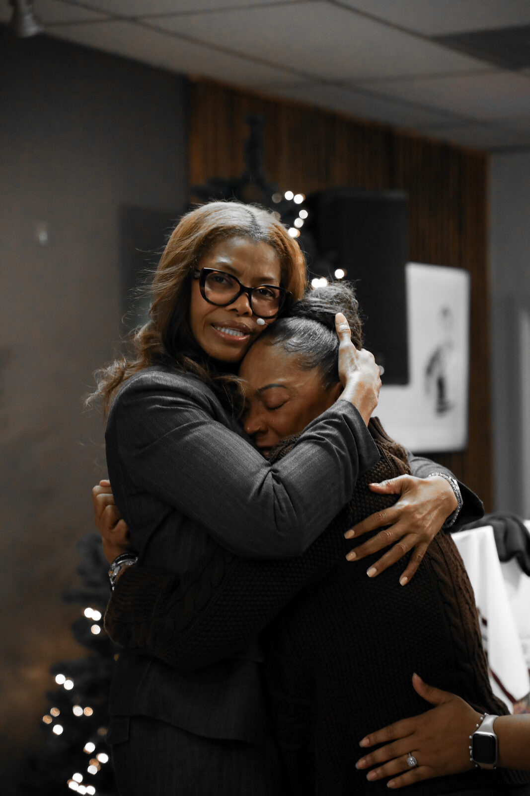 Two members embracing after service